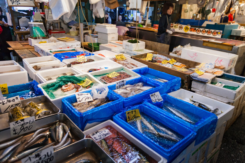 TOKYO - MAY 11: Shoppers visit Tsukiji Fish Market on May 11, 2014 in Tokyo. It is the biggest wholesale fish and seafood market in the world.